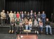 Students pose on a stage with Vt Justices