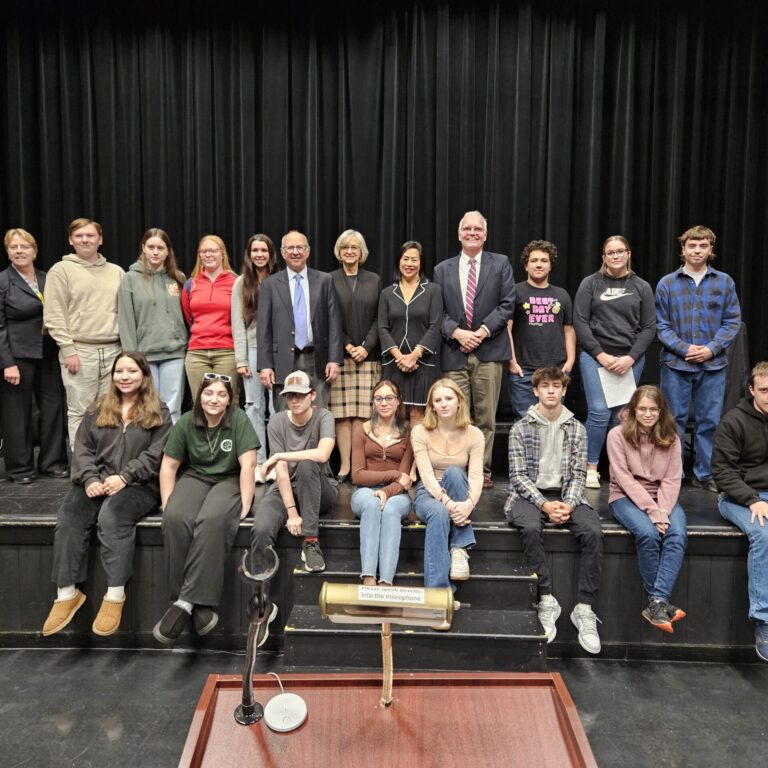 Students pose on a stage with Vt Justices