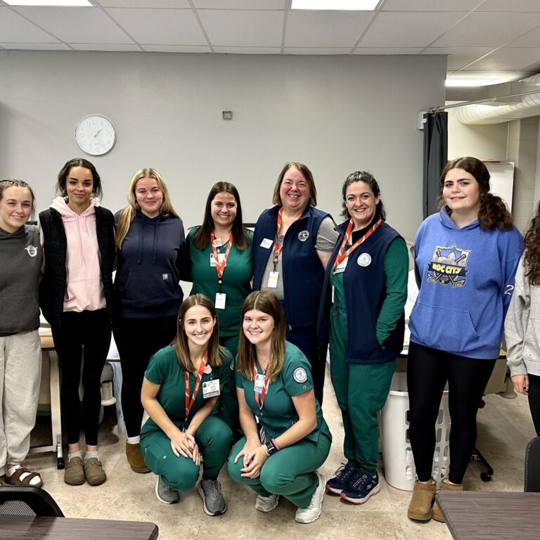 Stafford Health students surround visiting college nursing students