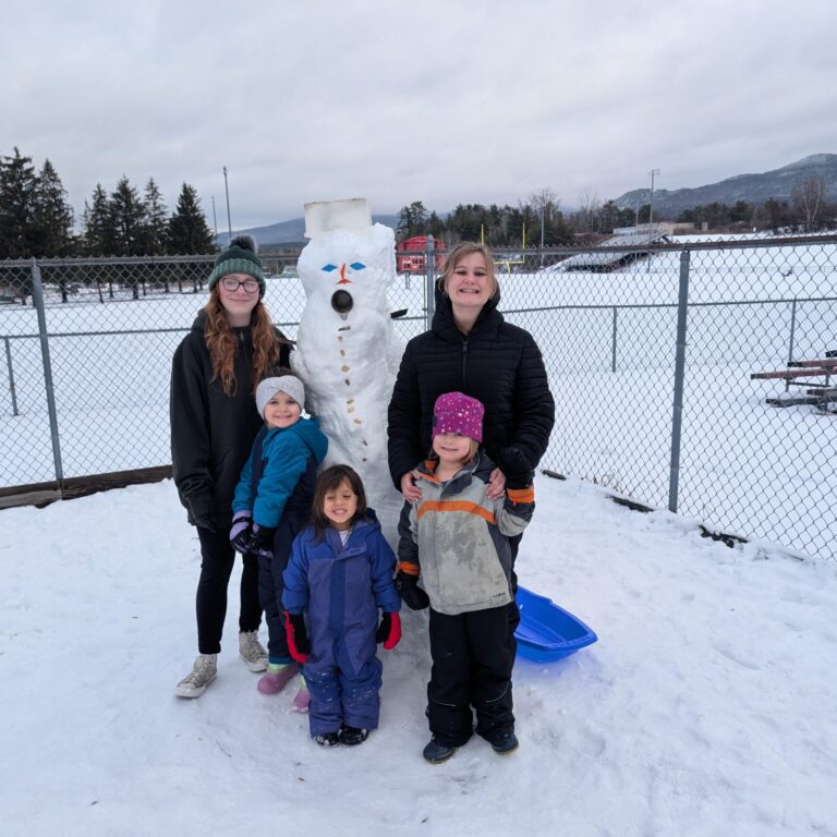 PXL_20260108_162748574 – Jacqueline Hemple 3 preschoolers gather around a snowman with two adults