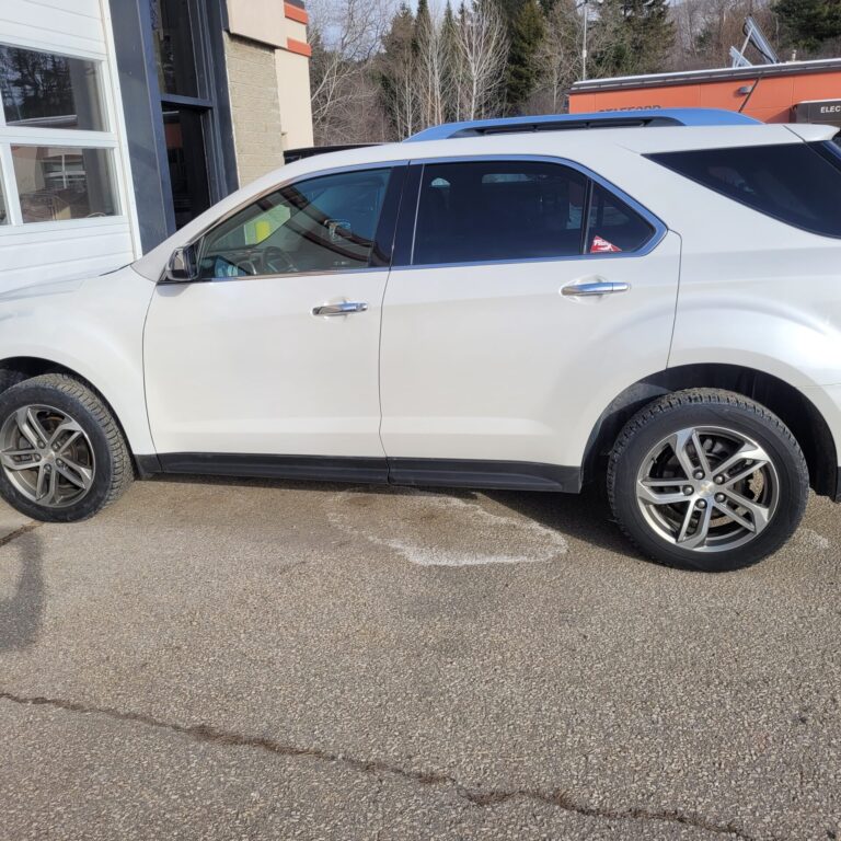 A white four door vehicle that looks brand new.