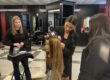 Paige attaches a hair extension to a manikin head