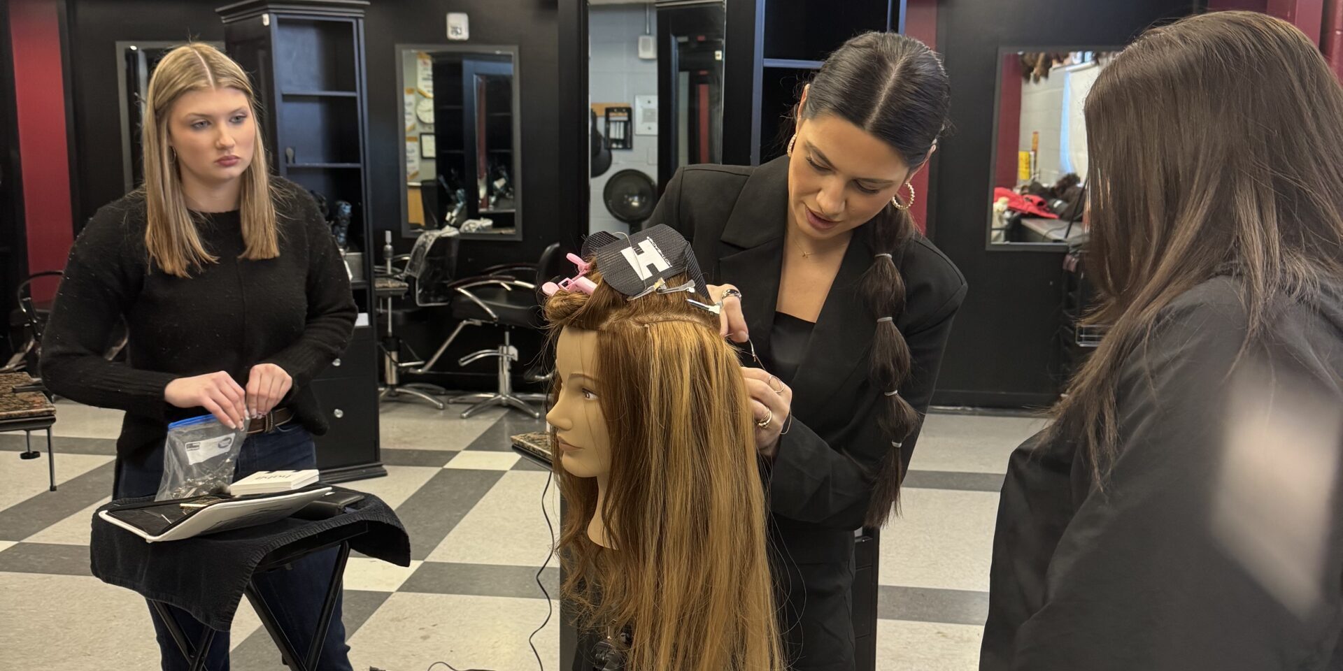 IMG_9641 Paige attaches a hair extension to a manikin head