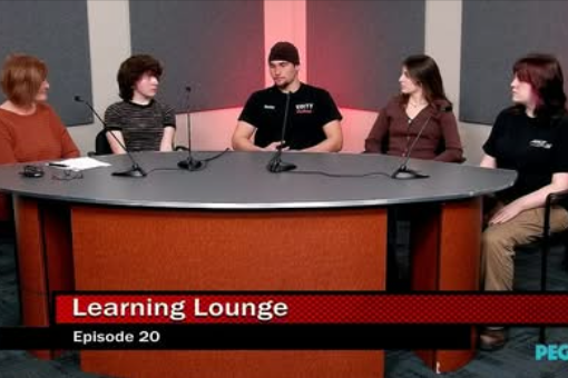 four students sit with one adult at a round table