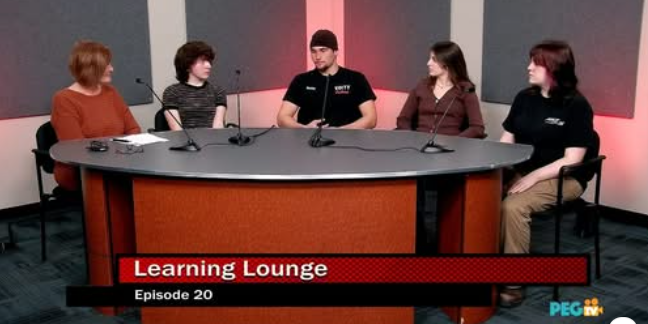 four students sit with one adult at a round table